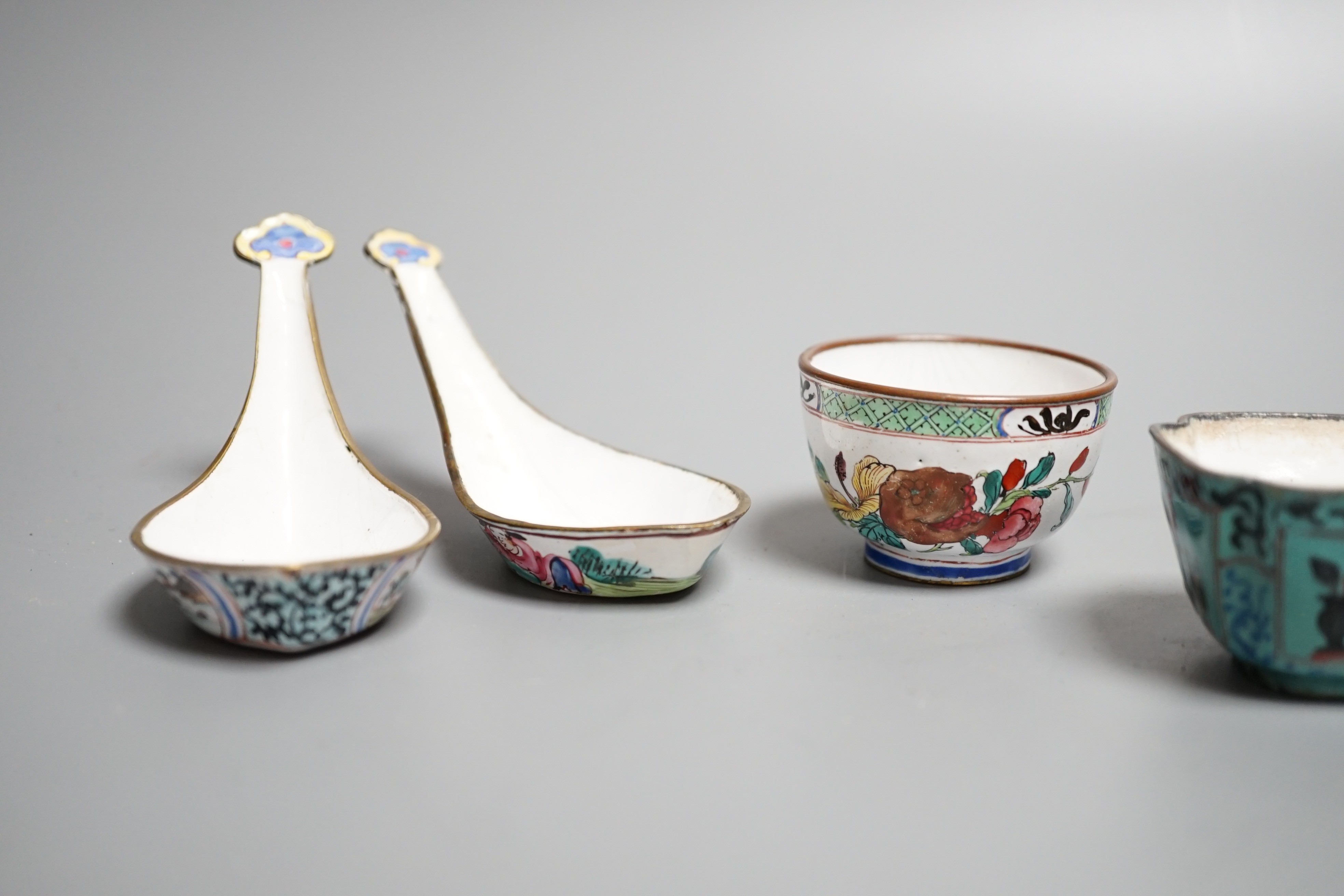 Nine pieces of Chinese Canton enamel wares, Qianlong period, including two enamel dishes, two rice spoons, and six various cups, largest 11cm